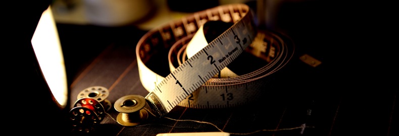 A measuring tape and other items to make a custom-tailored suit.