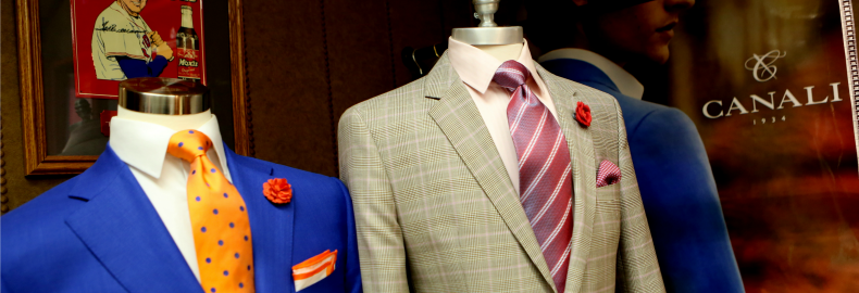 Mannequins showing off a variety of materials available for custom-tailored suits